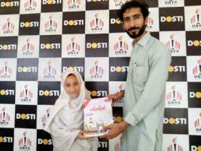 a child receives books from the director 2