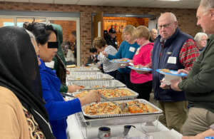 Lining up for Afghan food at the church event