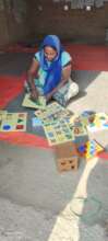 ECD teacher inspecting new classroom materials