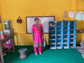 An ECD teacher in her improved classroom