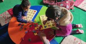 Children enjoy doing Nepali alphabet puzzles