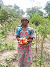 Women's Group member displays a harvest sample.