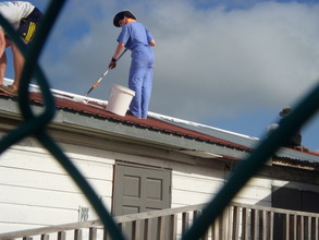 Applying white reflective coat paint (3)