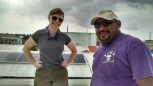 Volunteer and staff examine existing solar