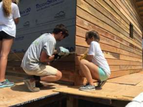 Volunteers work on housing construction