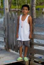 Boy in front of fence