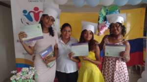 Graduates next to a teacher-volunteer