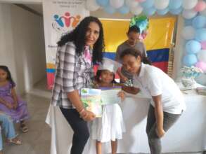 Graduated kid with her teachers