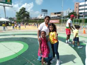 One of our volunteers teacher with two girls