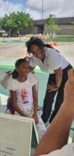 One of our volunteers teacher with a girl