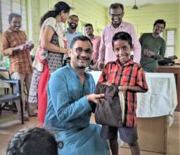 All smiles as student receives school uniform