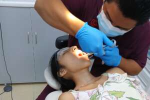 Student receiving discounted dental treatment