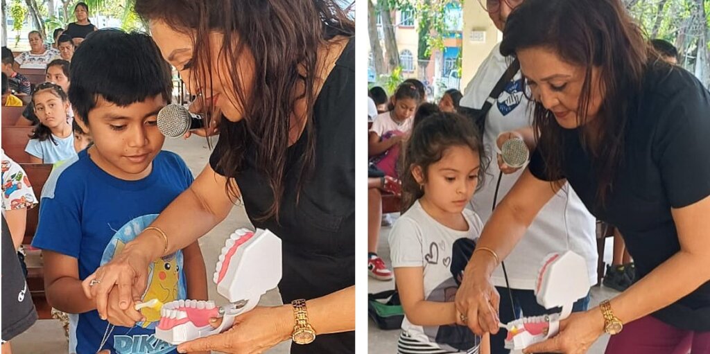Two students learning how to brush by a dentist.