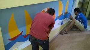 Volunteers Painting our Office Wall