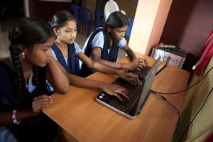 Young girls developing computer skills