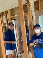 2 regular Volunteers  doing a muck and gut job