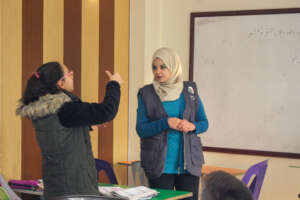 Teacher Hanine listening to a student