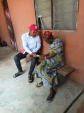 Our Project Leader supporting a poor elderly woman