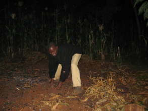 At home, deaf farmer collecting coal fuel