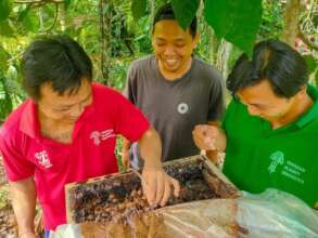 Ikwanto enthusiastically monitors bee hives