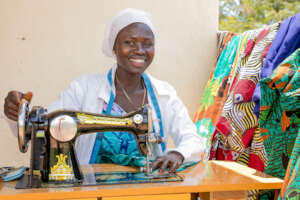 A tailor, makes dress on her sewing machine
