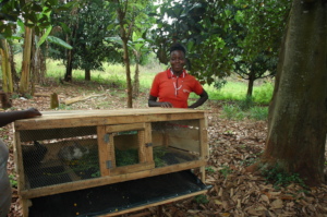 A female farmer with her complete rabbit cage
