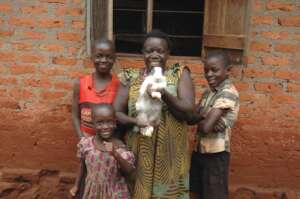 A happy family pause with their fully grown rabbit