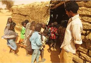 Ingui students enter thatched classroom