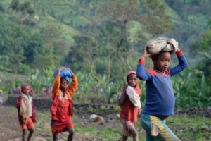Children carry sand to project site