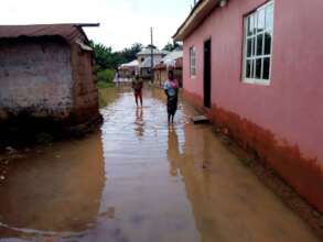 Nigerians navigate their flooded community.