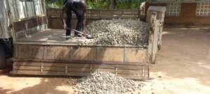 Community members contributing stones for kitchen