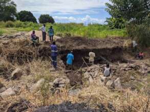 Community volunteers help contractors build bridge