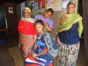 A widow with her family after getting a title deed