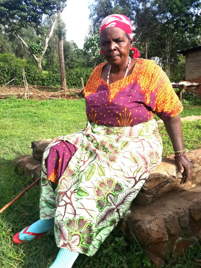 One of beneficiary sits on her husband grave.