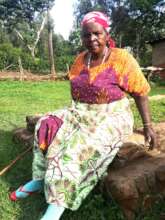 One of beneficiary sits on her husband grave.