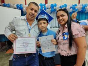 Student with his family holding diploma and medal