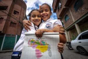 Students with homework next to the School
