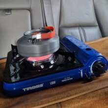 Brewing coffee in his car