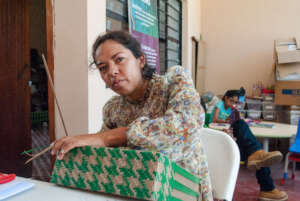 Caridad, bag weaving apprentice