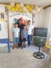 Mother head of household, their kids and volunteer
