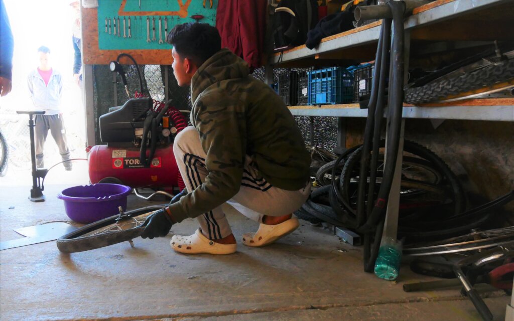 Our bicycle mechanic student, fixing a bicycle