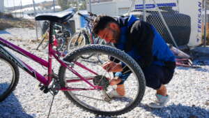 Our bicycle mechanic student, fixing a bicycle