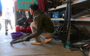 Our bicycle mechanic student, fixing a bicycle