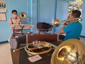 Youth practicing with trumpets.