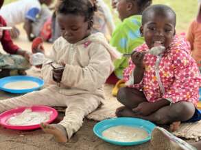 Preschool students enjoying peanut butter porridge