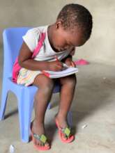 A preschool student practicing letters