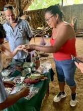 Irene showing Maleku herbs to SoulGives BOD member