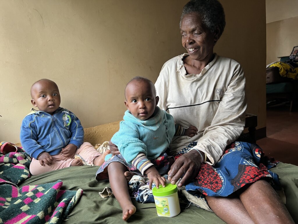 A widowed grandmother with her twin grandchildren