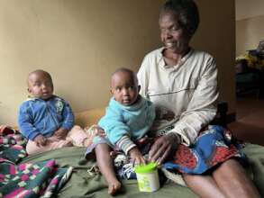 A widowed grandmother with her twin grandchildren