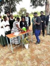 A teacher prepares a birthday cake for tree plant